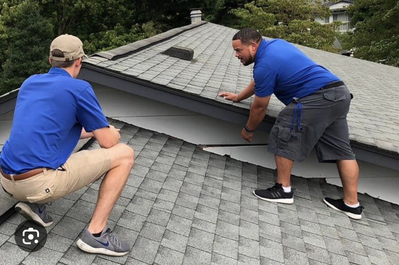 Two men working on a roof